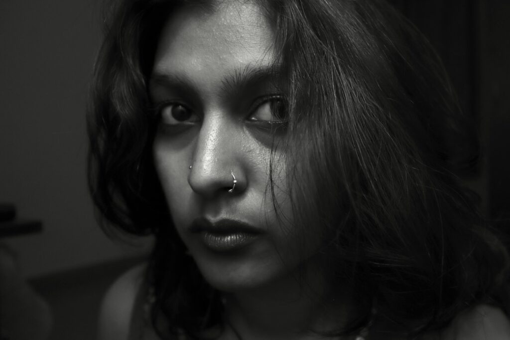 A black and white portrait of a young woman.